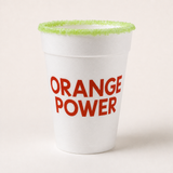 A white styrofoam cup with 'ORANGE POWER' printed in red text on the front, featuring a bright green sugar-coated rim, set against a plain off-white background.