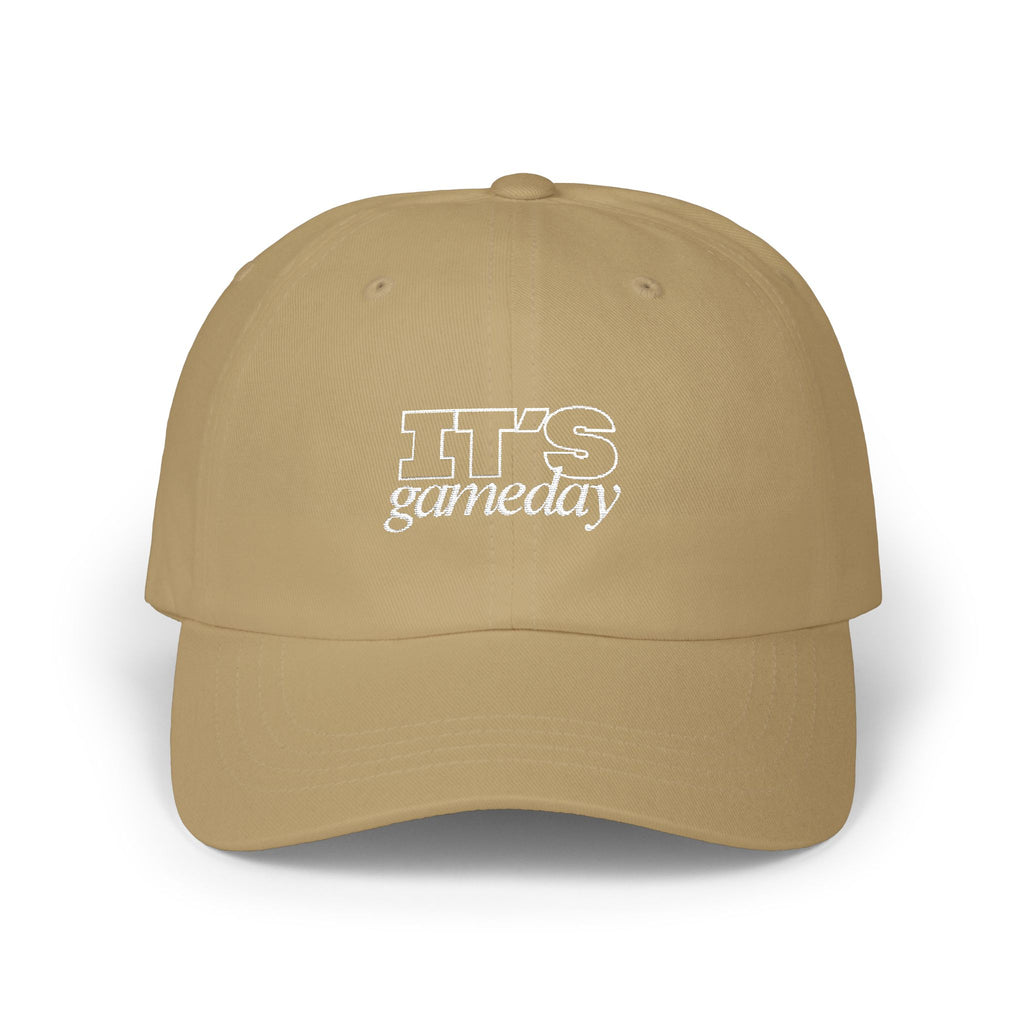 A tan baseball cap with white embroidered text reading 'It's Gameday'