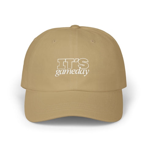 A tan baseball cap with white embroidered text reading 'It's Gameday'