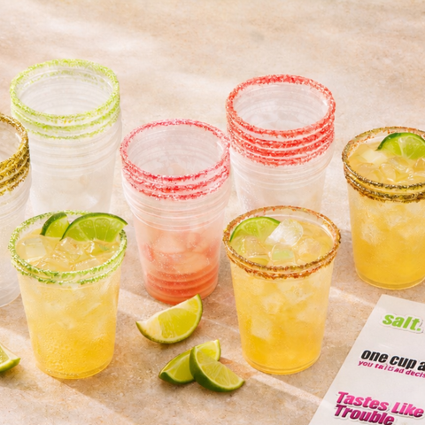 Flat lay of The Bad Decisions Bundle featuring 48 flavored Rita Rims party cups with Salt & Lime, Strawberry, and Jalapeño rims and citrus punch.