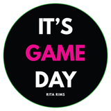 A circular black graphic with a thin green border and bold text reading “IT’S GAME DAY” in white and bright pink, with “RITA RIMS” in small white text below.