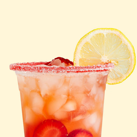 Fruity drink with lemon slice and strawberry on a yellow background