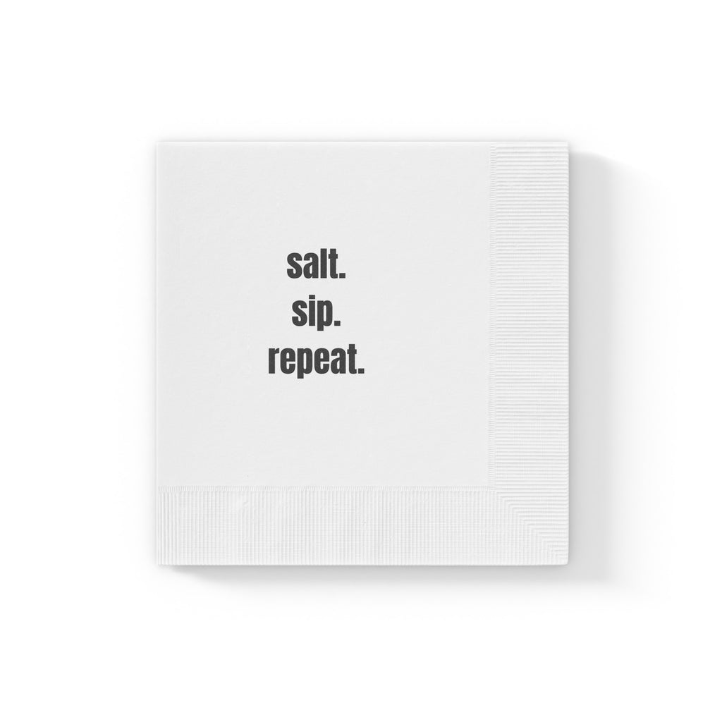 A white paper napkin with the words 'salt. sip. repeat'