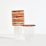 Clear plastic cups with brown rim on a white background