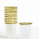 Two glasses with green rimmed glasses on a white background