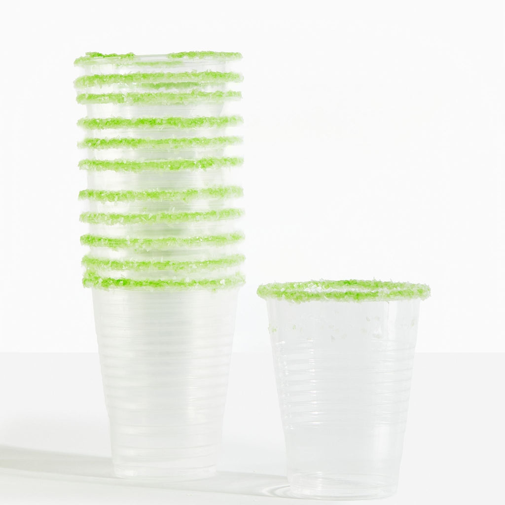 Clear plastic cups with green rim on a white background
