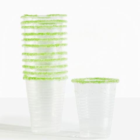Clear plastic cups with green rim on a white background