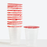 Clear plastic cups with red rim on a white background