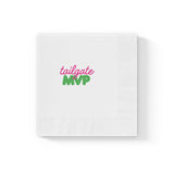 Alt text: White Tailgate MVP cocktail napkin with pink and green printed design